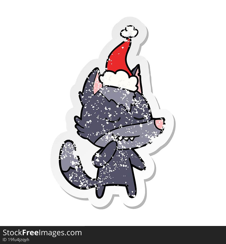 friendly distressed sticker cartoon of a wolf wearing santa hat