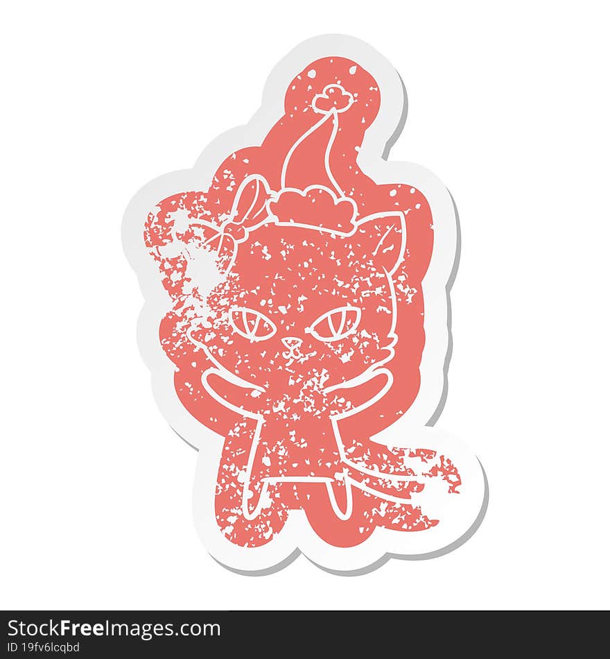 cute quirky cartoon distressed sticker of a cat wearing santa hat