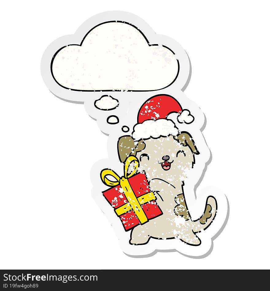 cute cartoon puppy with christmas present and hat and thought bubble as a distressed worn sticker