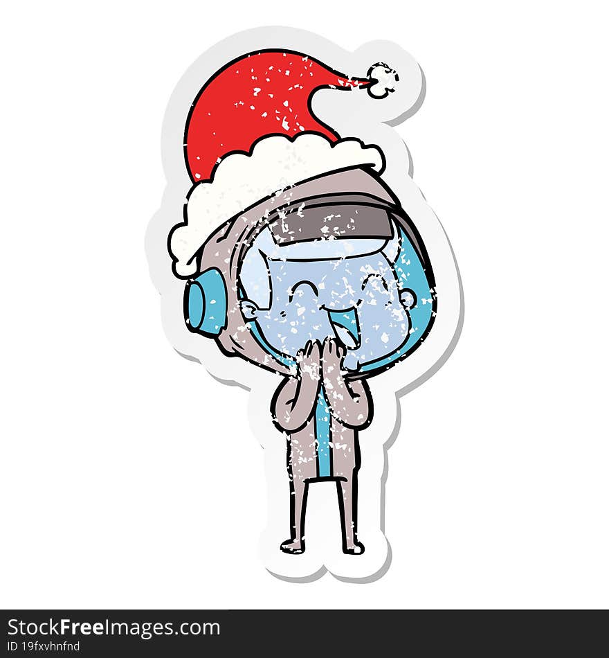 happy distressed sticker cartoon of a astronaut wearing santa hat