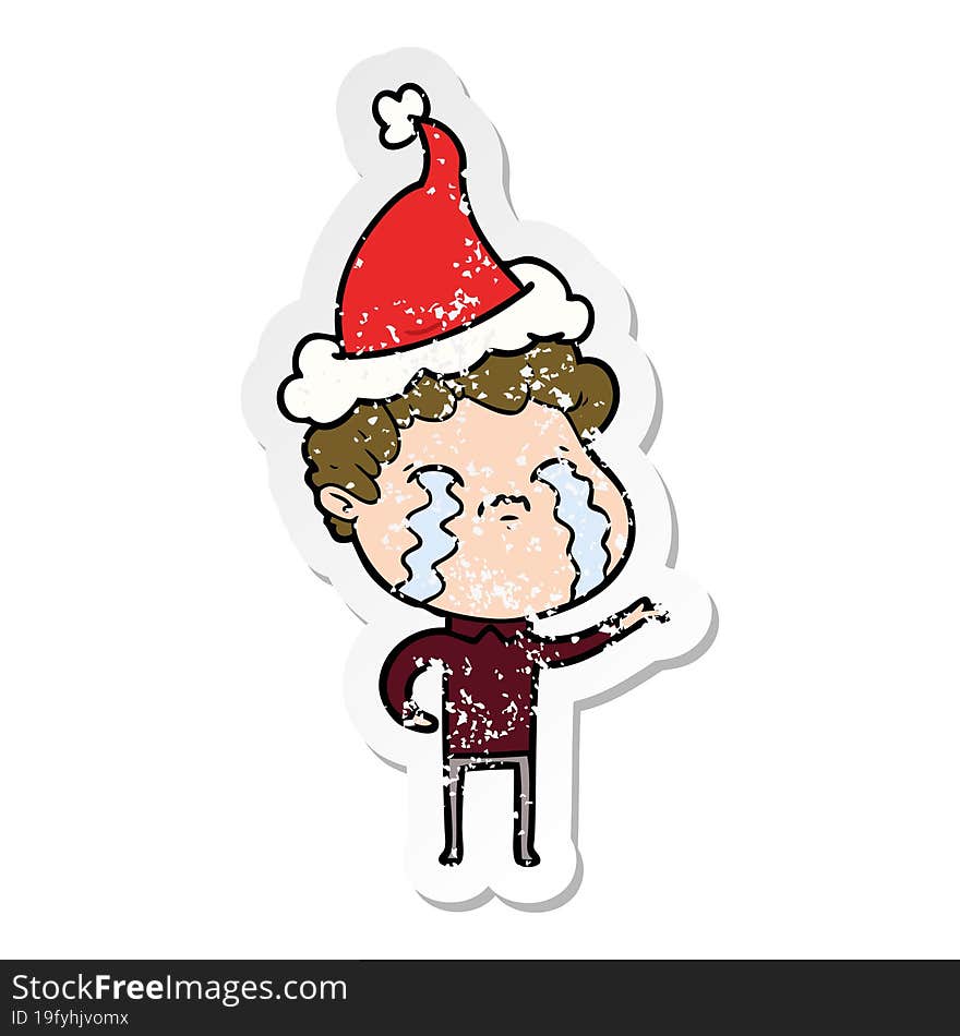 distressed sticker cartoon of a man crying wearing santa hat