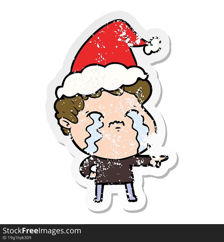 distressed sticker cartoon of a man crying wearing santa hat