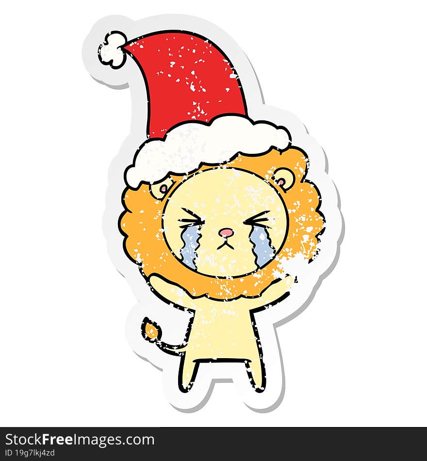 distressed sticker cartoon of a crying lion wearing santa hat