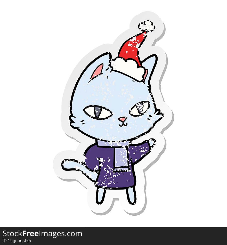 distressed sticker cartoon of a cat staring wearing santa hat