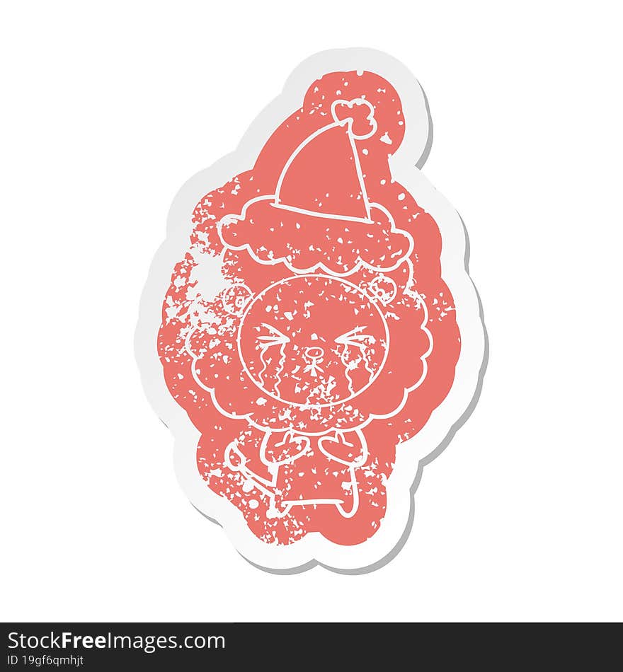 cartoon distressed sticker of a crying lion wearing santa hat