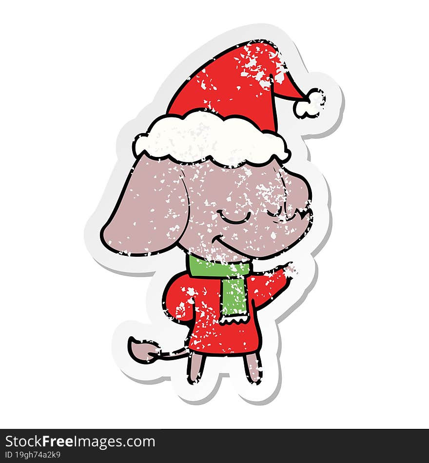 distressed sticker cartoon of a smiling elephant wearing scarf wearing santa hat