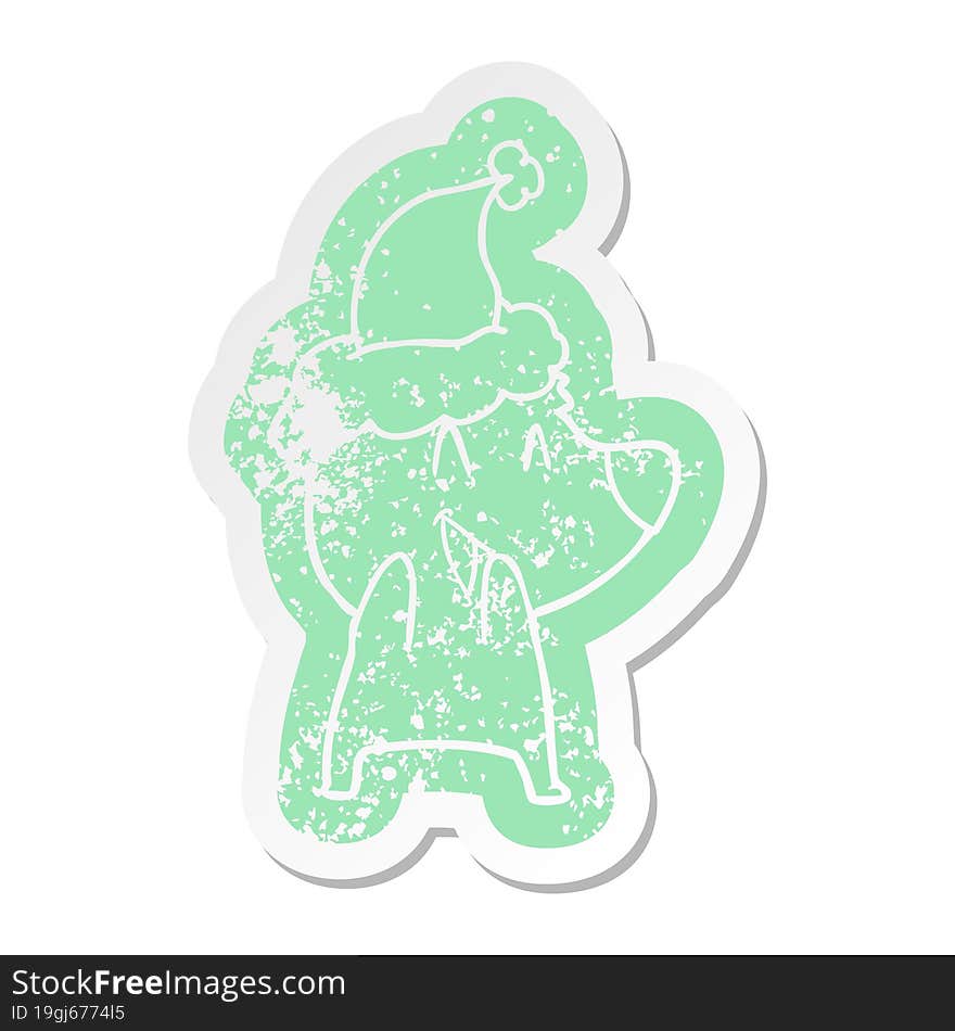 laughing polar bear quirky cartoon distressed sticker of a wearing santa hat