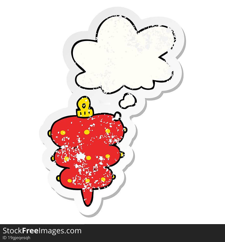 cartoon christmas decoration and thought bubble as a distressed worn sticker