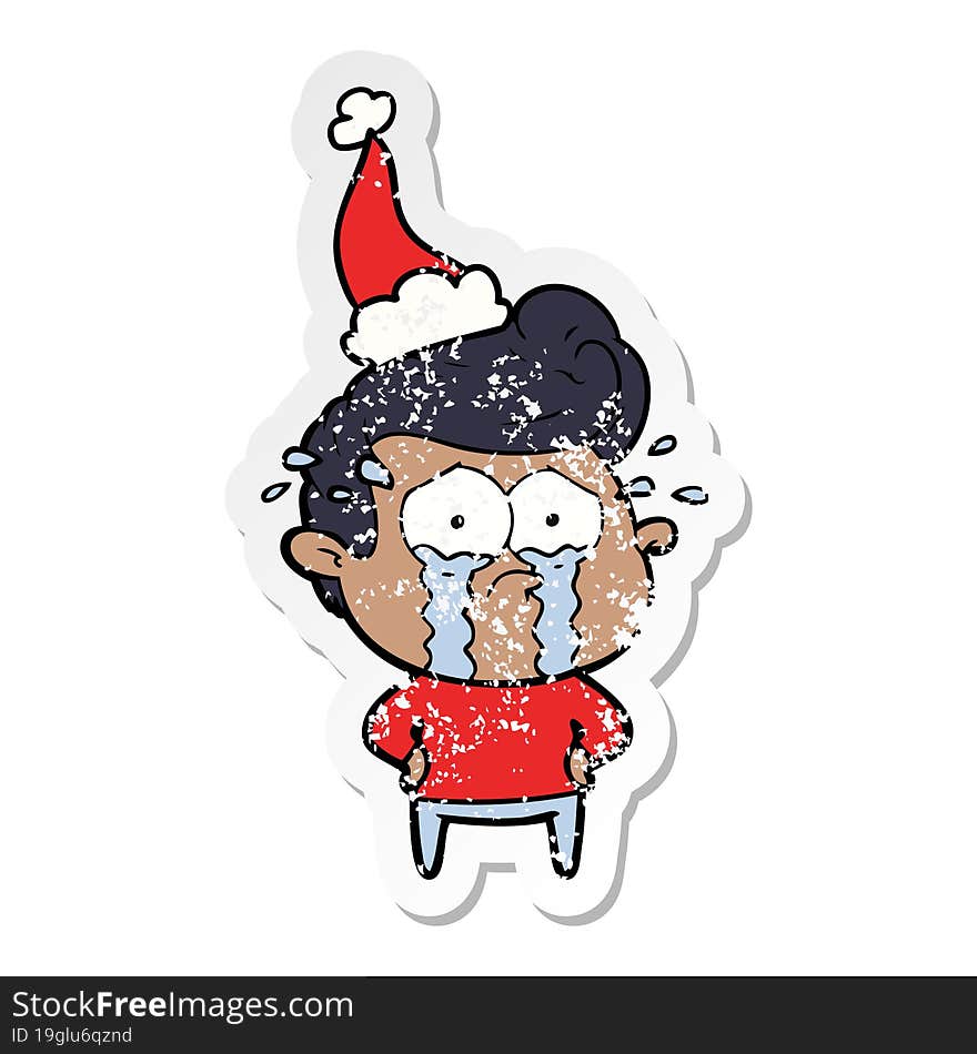 distressed sticker cartoon of a crying man wearing santa hat