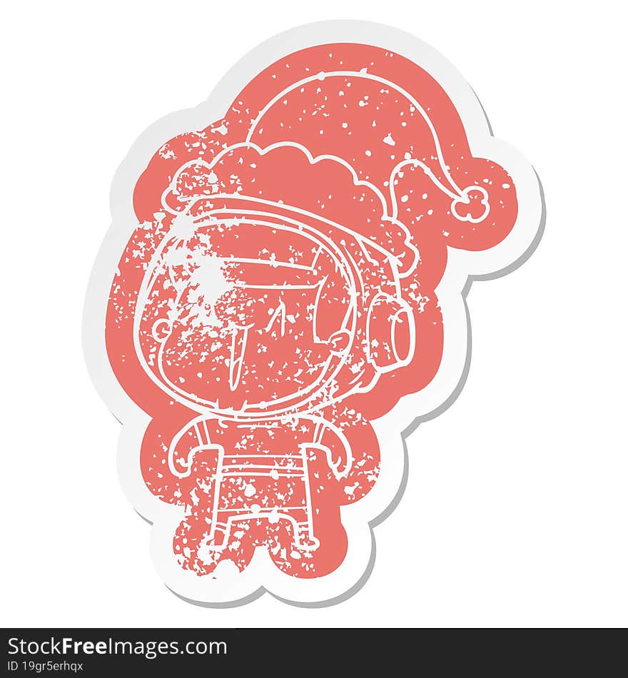 quirky cartoon distressed sticker of a astronaut man wearing santa hat