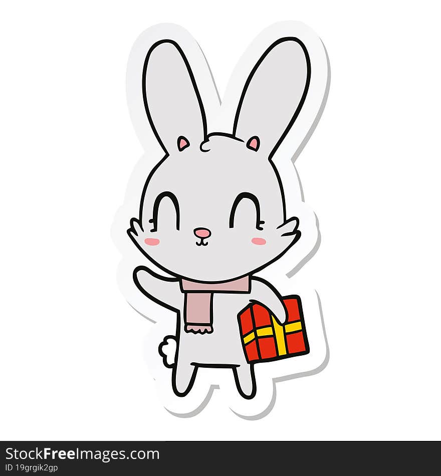 sticker of a cute cartoon rabbit with christmas present