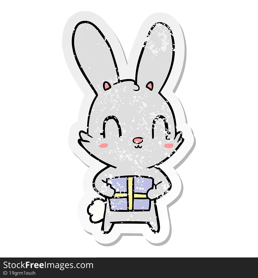 distressed sticker of a cute cartoon rabbit with present