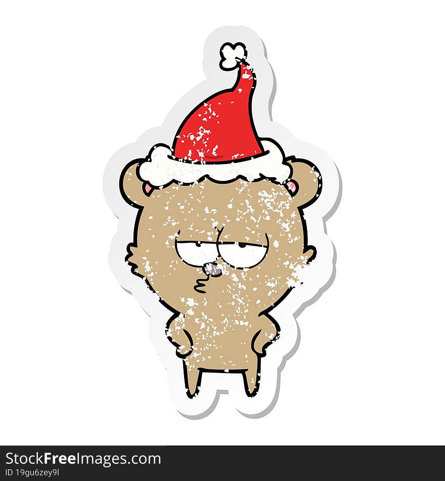 bored bear distressed sticker cartoon of a wearing santa hat