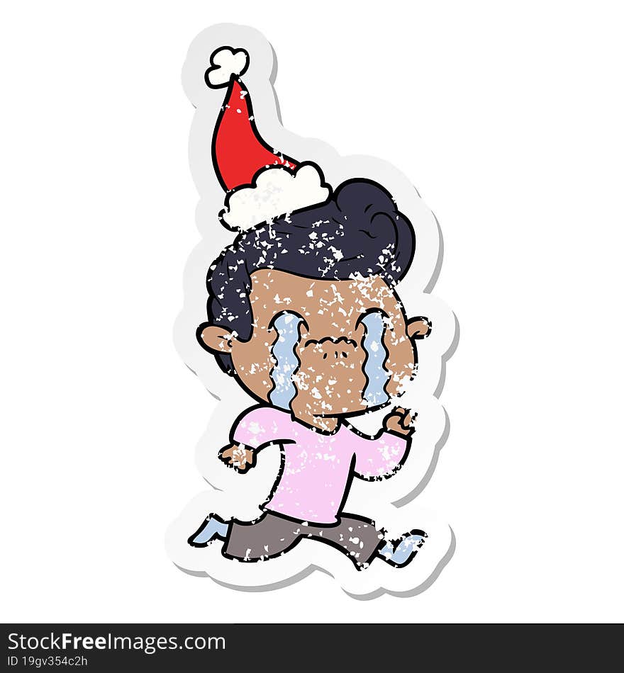 distressed sticker cartoon of a man crying wearing santa hat