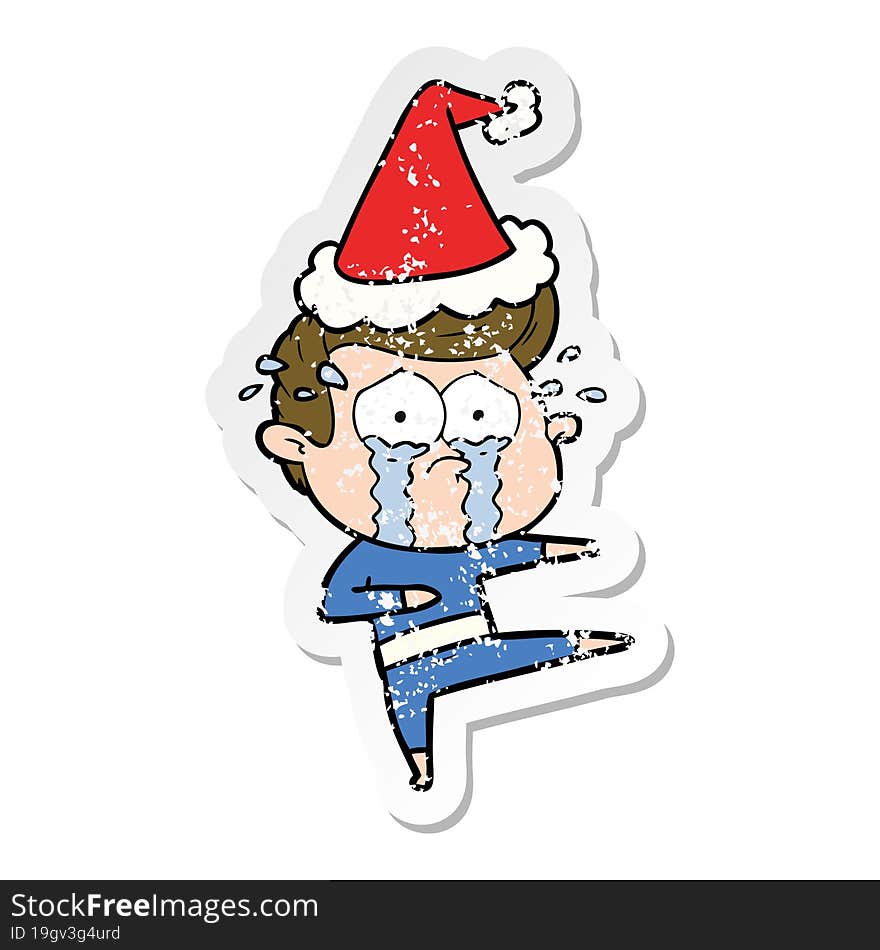 hand drawn distressed sticker cartoon of a crying dancer wearing santa hat