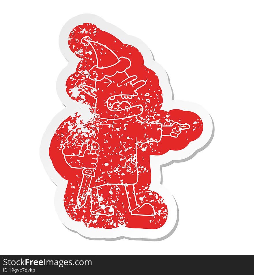 Cartoon Distressed Sticker Of A Goblin With Knife Wearing Santa Hat