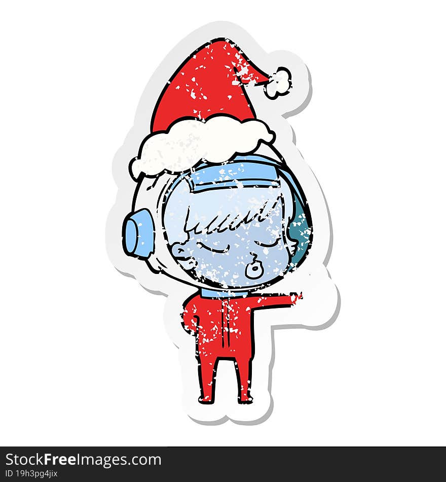 hand drawn distressed sticker cartoon of a pretty astronaut girl giving thumbs up wearing santa hat