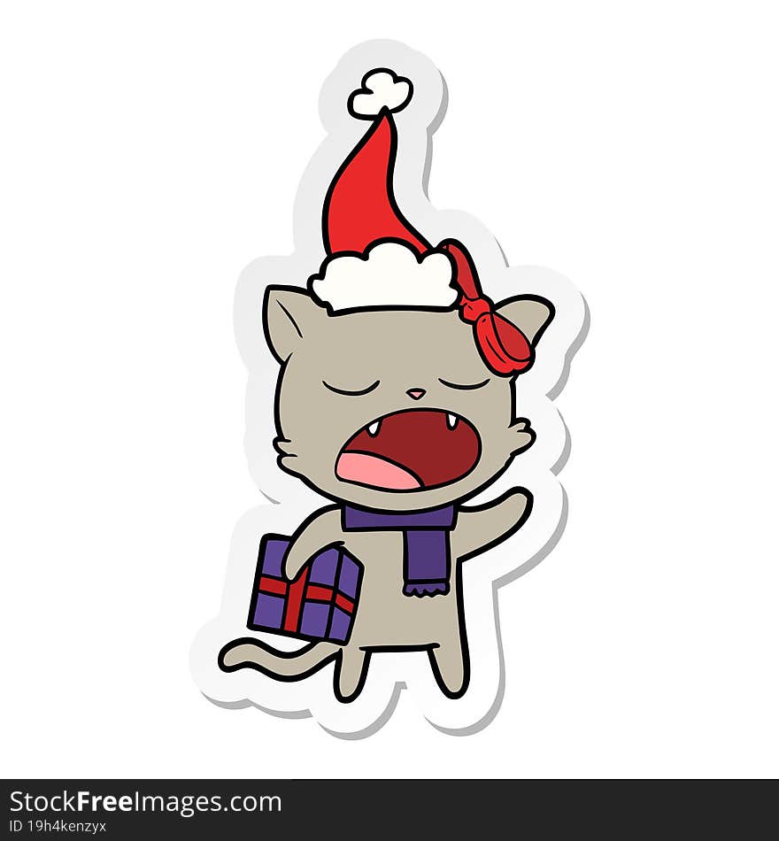 Sticker Cartoon Of A Cat With Christmas Present Wearing Santa Hat