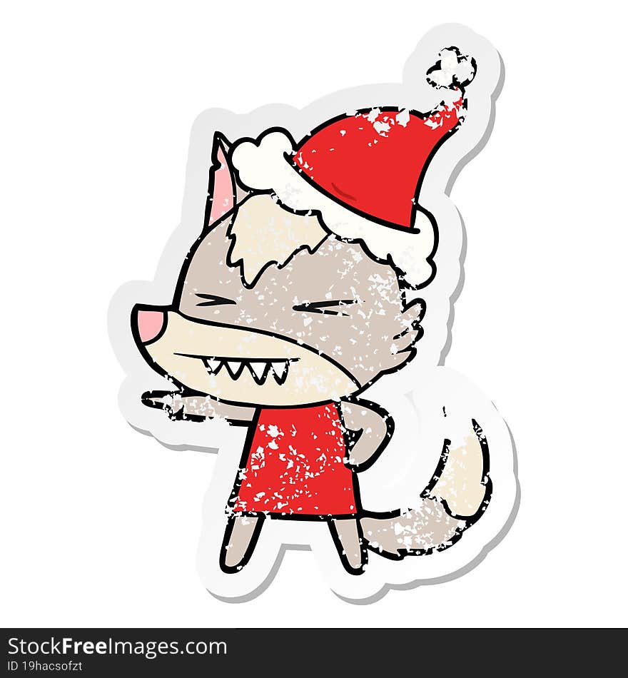 angry wolf distressed sticker cartoon of a wearing santa hat