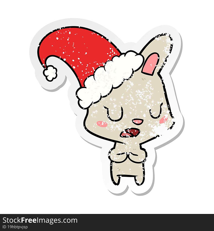 Distressed Sticker Of A Cartoon Rabbit Wearing Christmas Hat