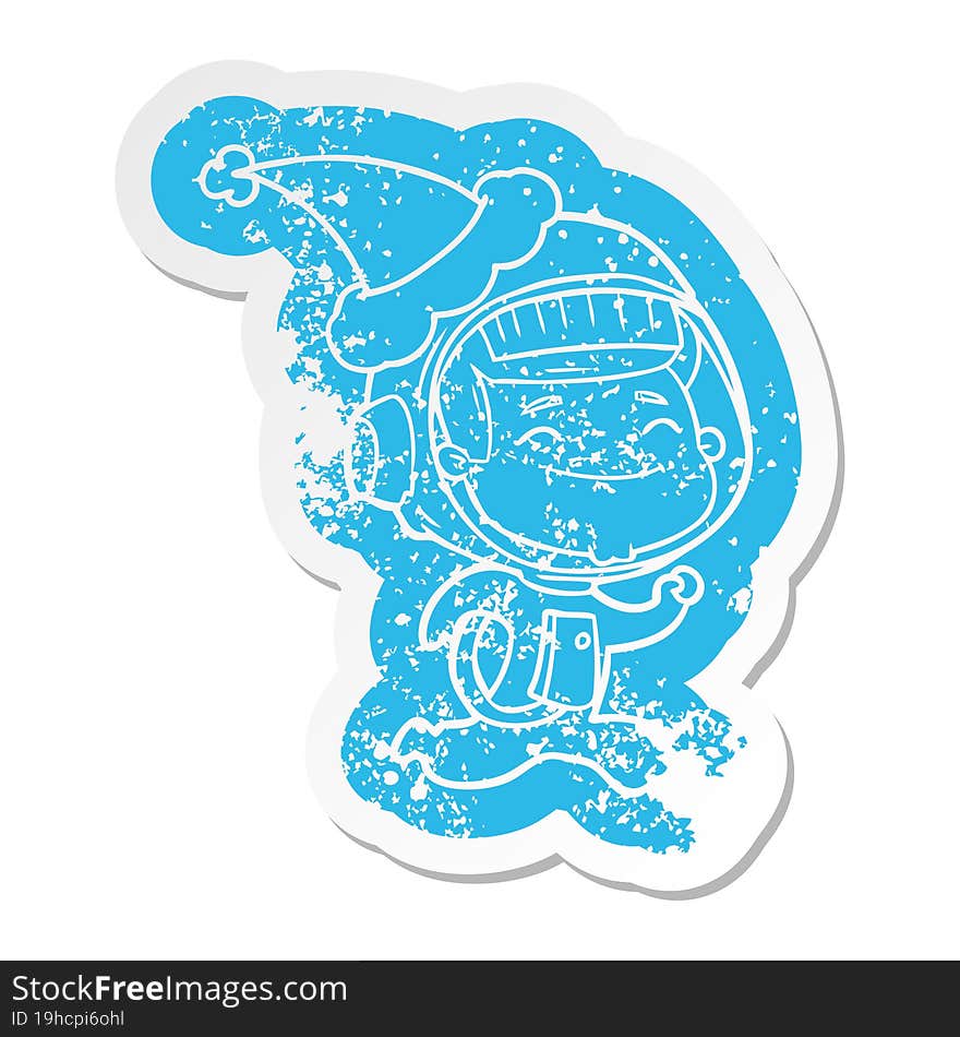 happy cartoon distressed sticker of a astronaut wearing santa hat