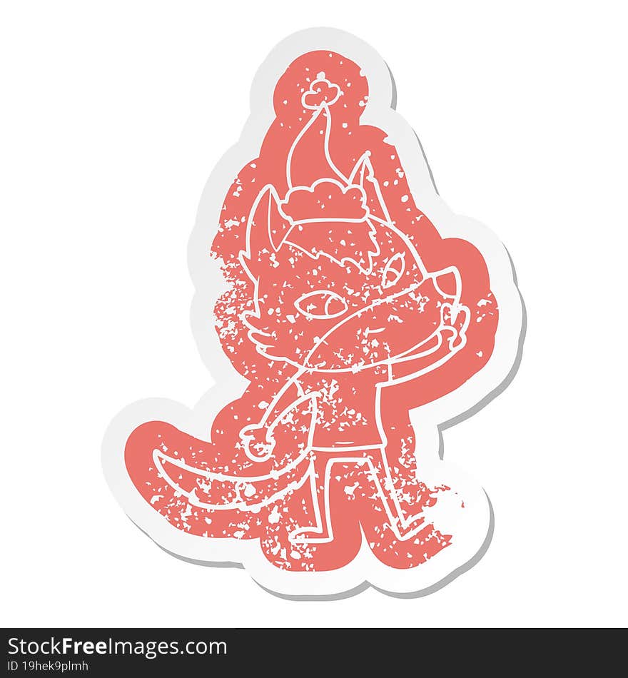 friendly cartoon distressed sticker of a wolf giving peace sign wearing santa hat