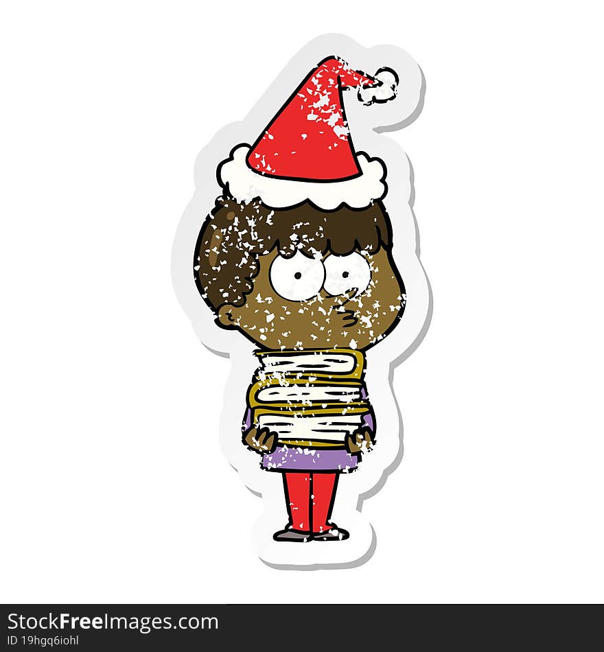 distressed sticker cartoon of a curious boy with lots of books wearing santa hat