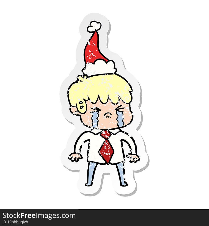 distressed sticker cartoon of a boy crying wearing santa hat