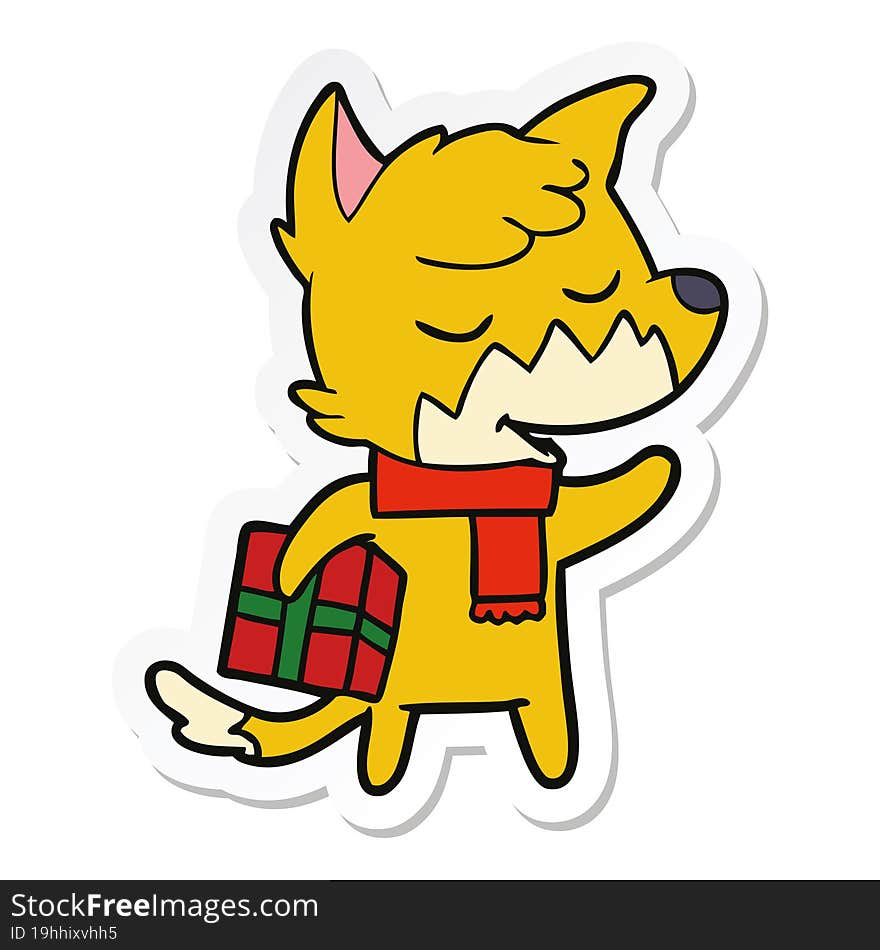 sticker of a friendly cartoon fox with christmas present