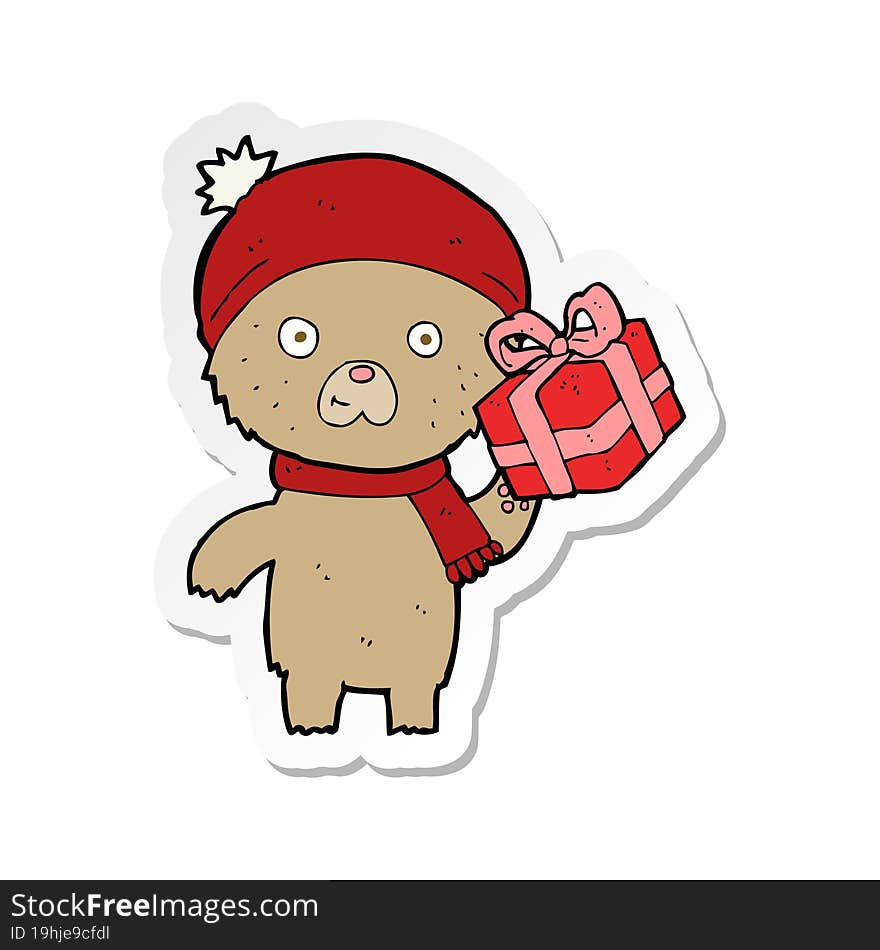 Sticker Of A Cartoon Christmas Teddy Bear With Present