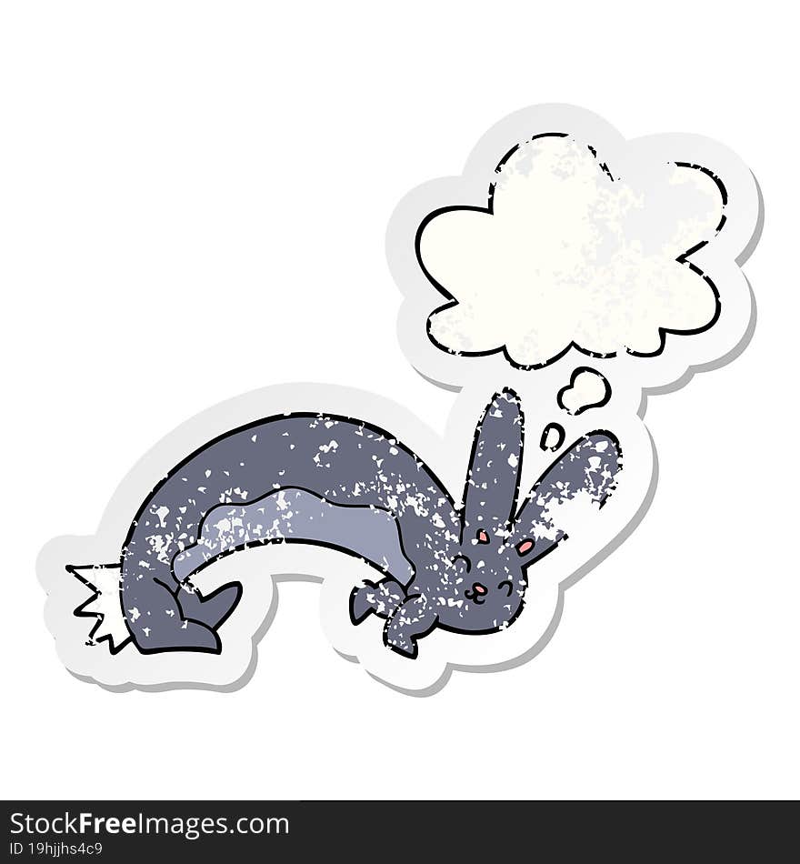 funny cartoon rabbit with thought bubble as a distressed worn sticker