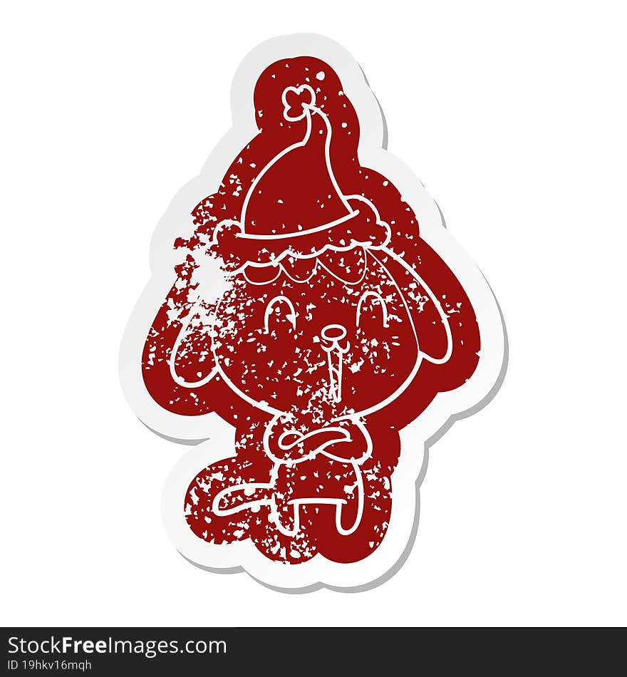 cute cartoon distressed sticker of a dog wearing santa hat