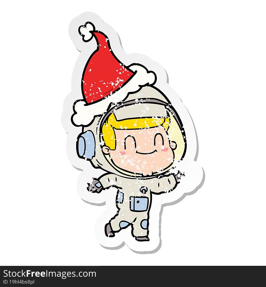 happy distressed sticker cartoon of a astronaut man wearing santa hat