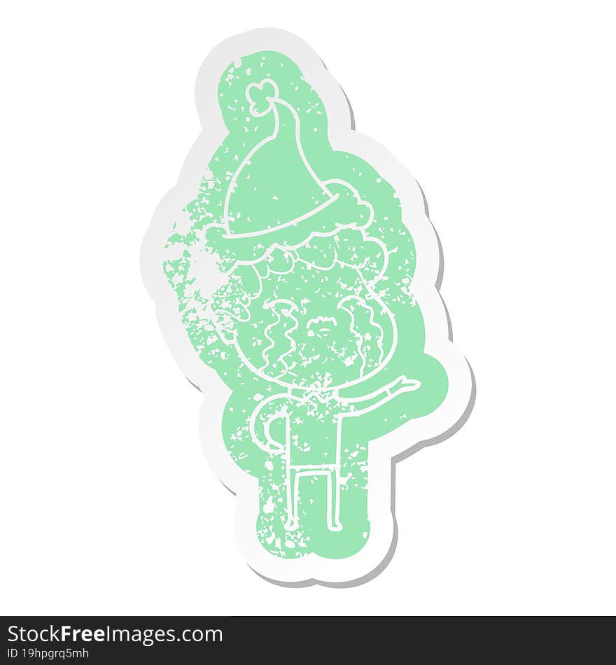 cartoon distressed sticker of a man crying wearing santa hat