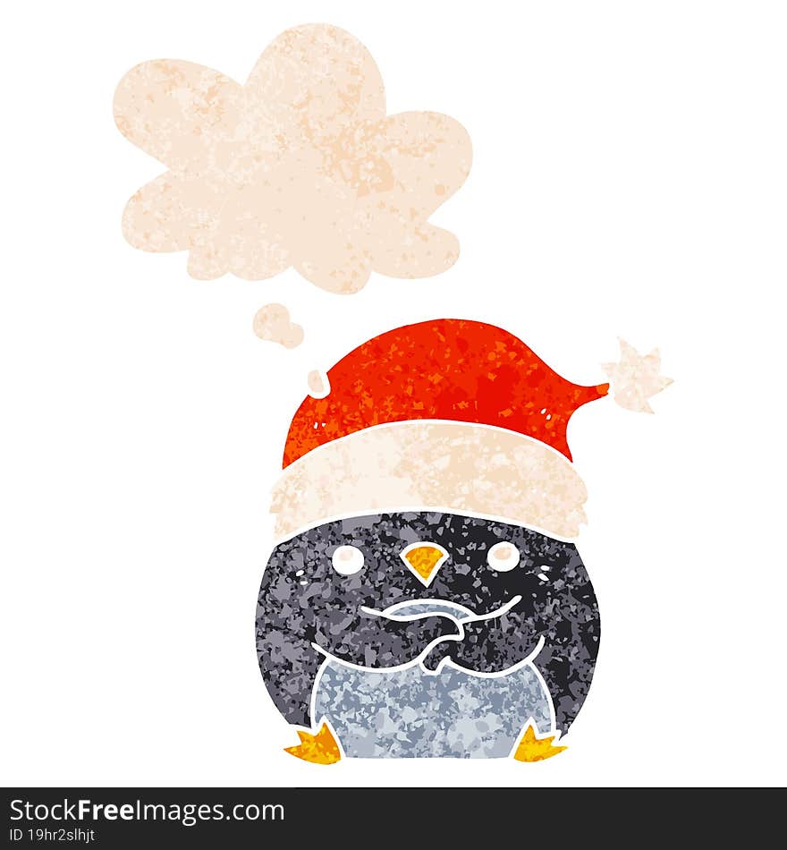 cute cartoon penguin wearing christmas hat and thought bubble in retro textured style