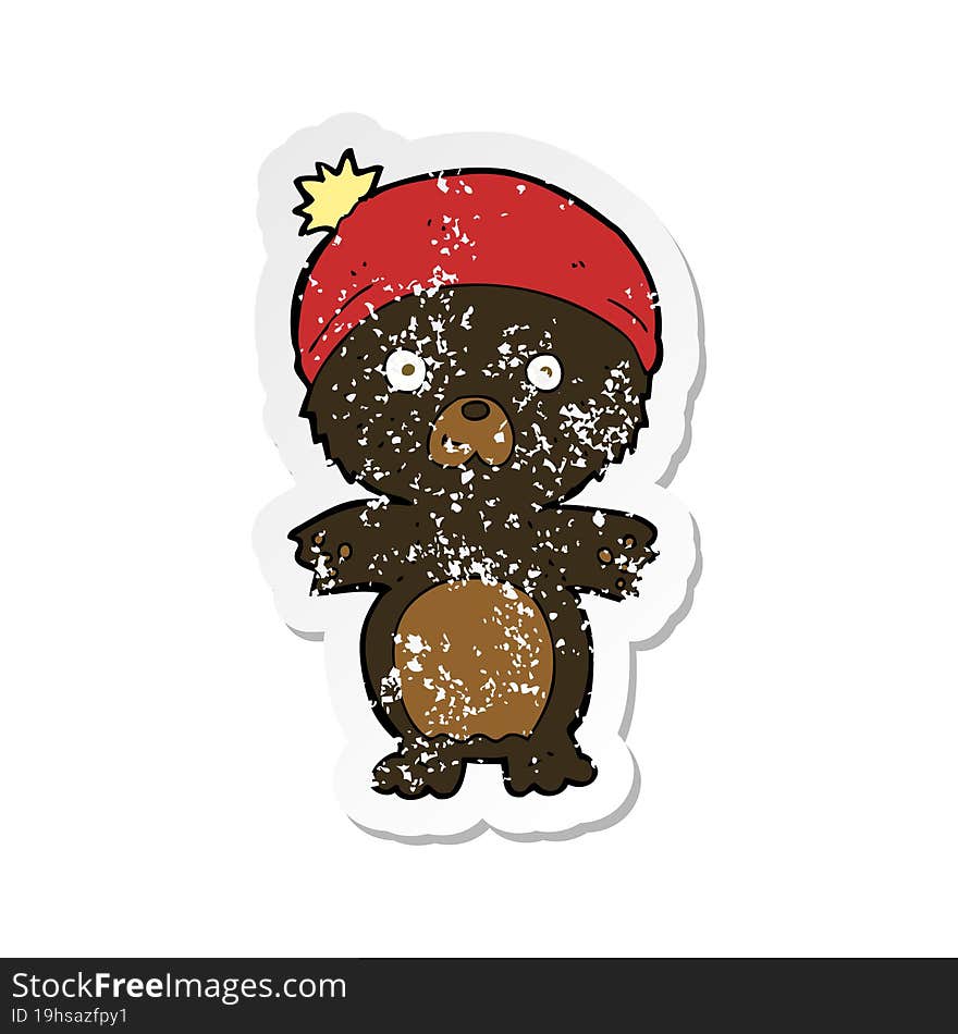 retro distressed sticker of a cartoon cute black bear in hat