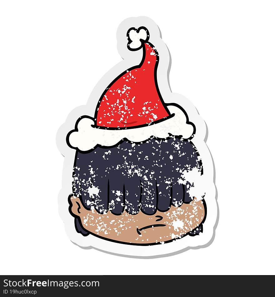 distressed sticker cartoon of a face with hair over eyes wearing santa hat