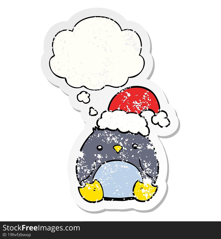 cute cartoon penguin wearing christmas hat and thought bubble as a distressed worn sticker