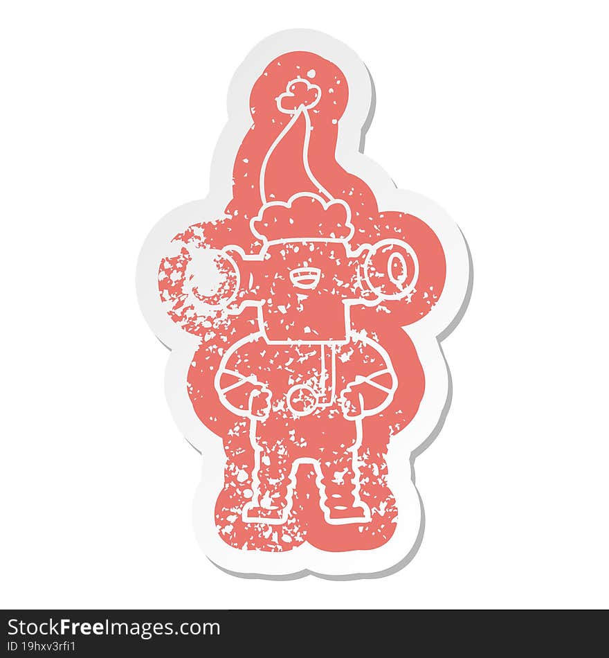 friendly quirky cartoon distressed sticker of a alien wearing santa hat