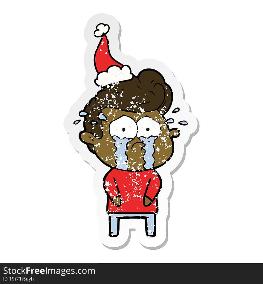 Distressed Sticker Cartoon Of A Crying Man Wearing Santa Hat