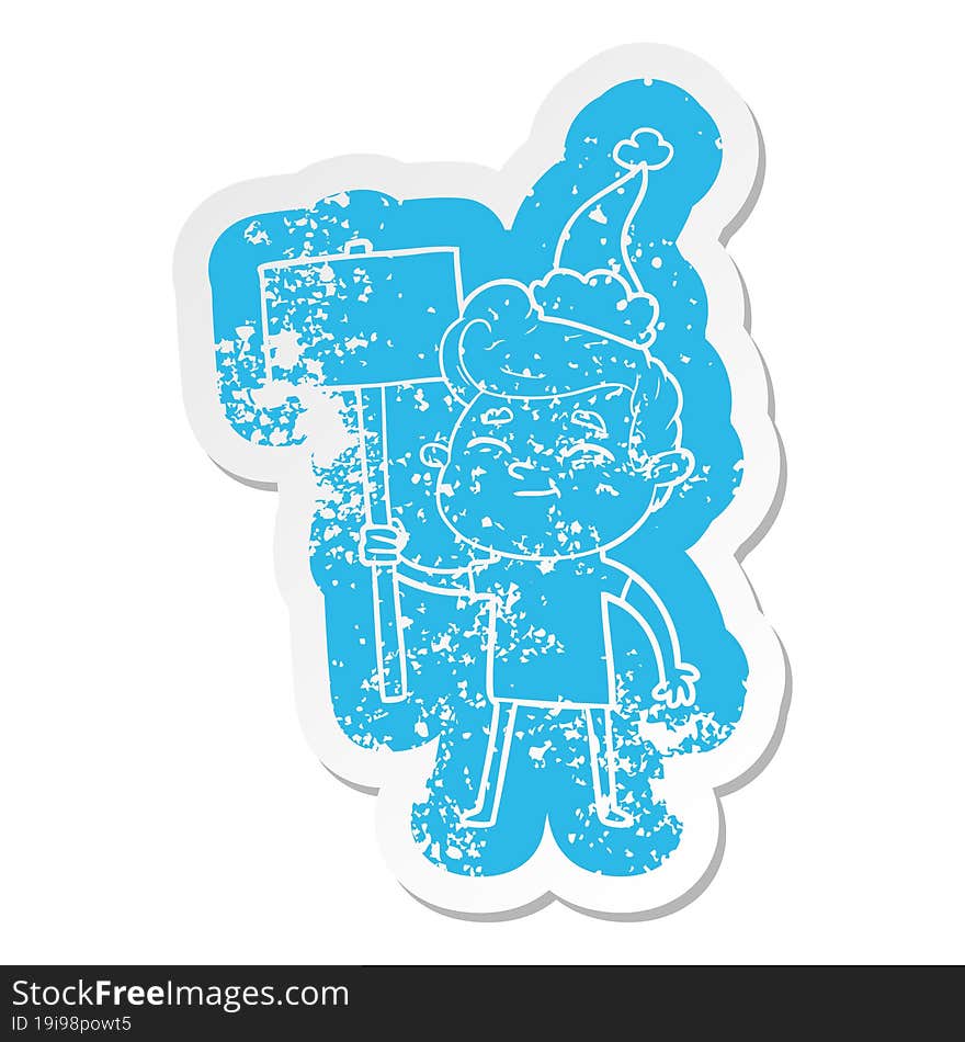 happy cartoon distressed sticker of a man with sign wearing santa hat