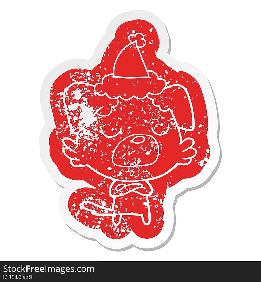 cartoon distressed sticker of a dog wearing santa hat