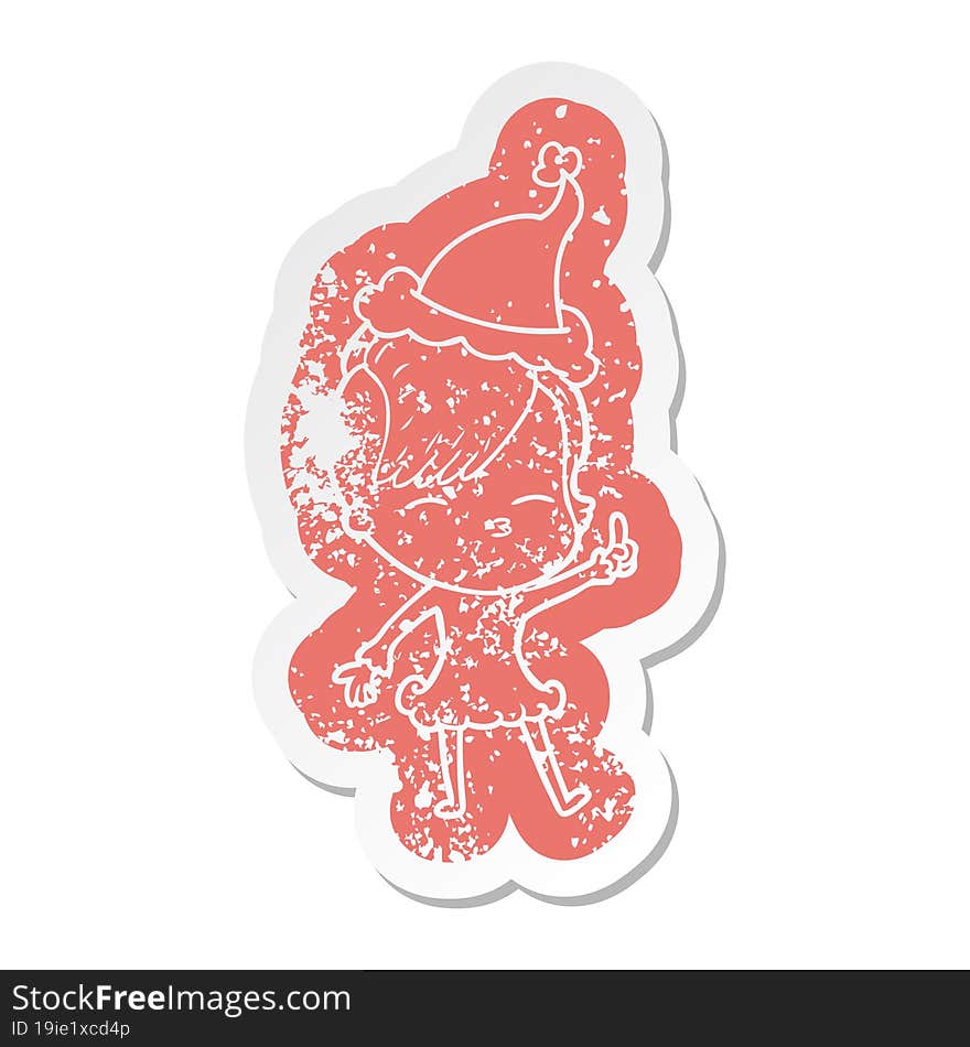 cartoon distressed sticker of a squinting girl wearing santa hat