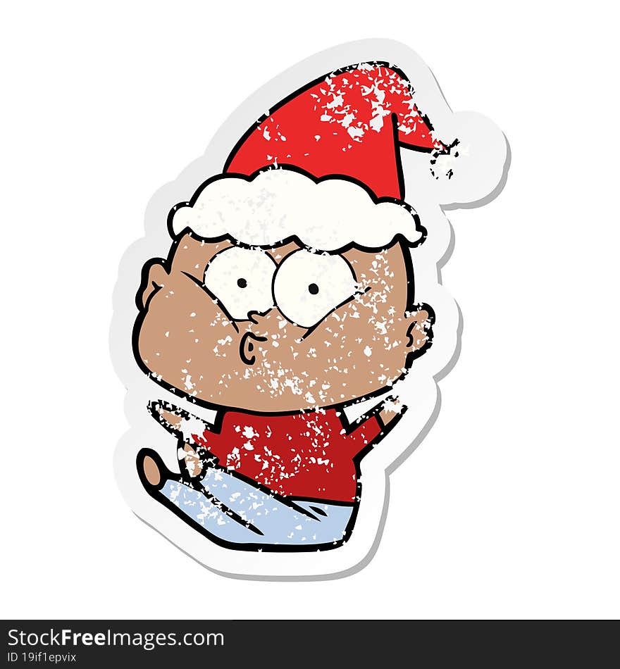 distressed sticker cartoon of a bald man staring wearing santa hat