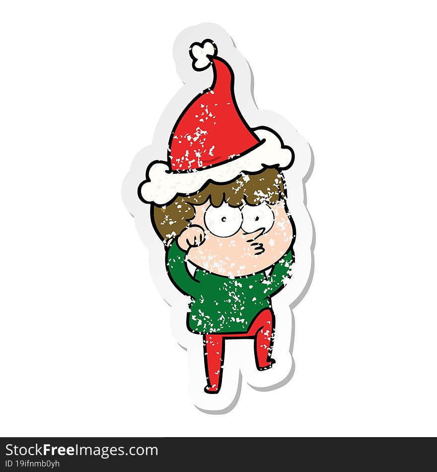 distressed sticker cartoon of a curious boy rubbing eyes in disbelief wearing santa hat