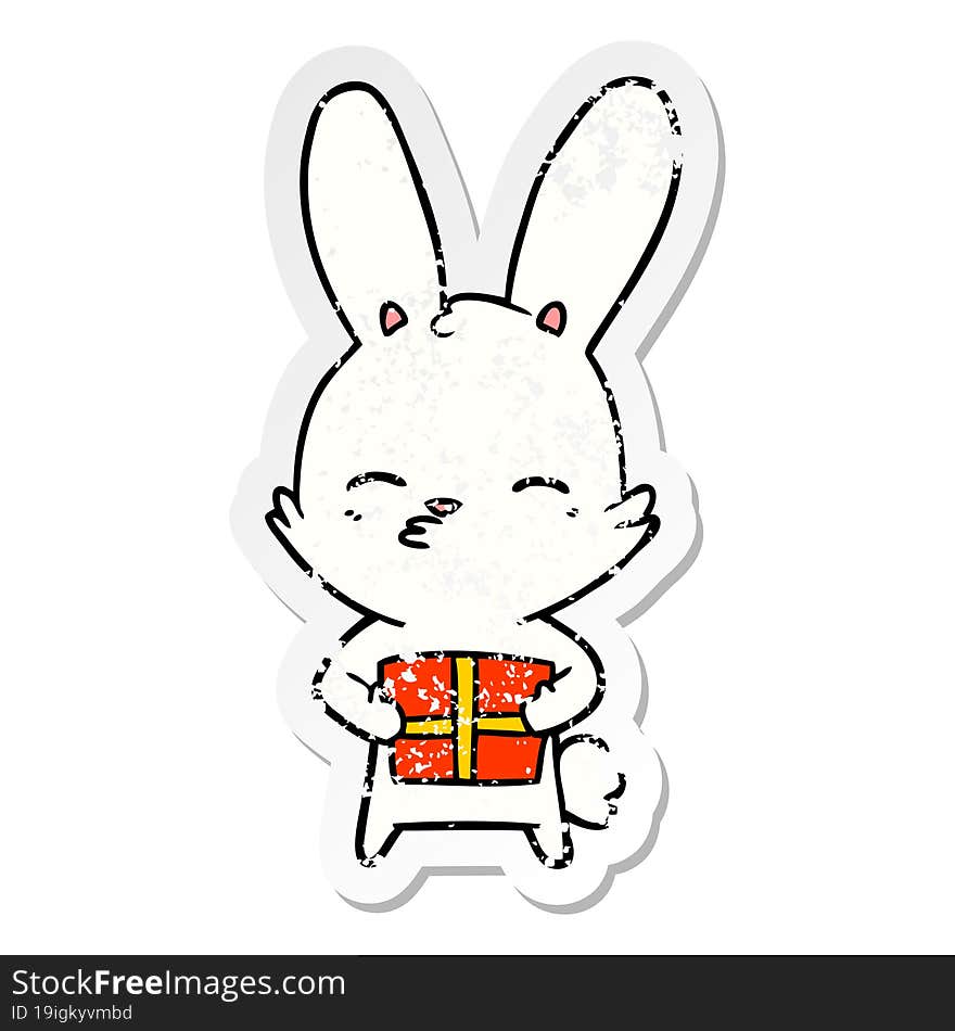 distressed sticker of a curious bunny cartoon with present