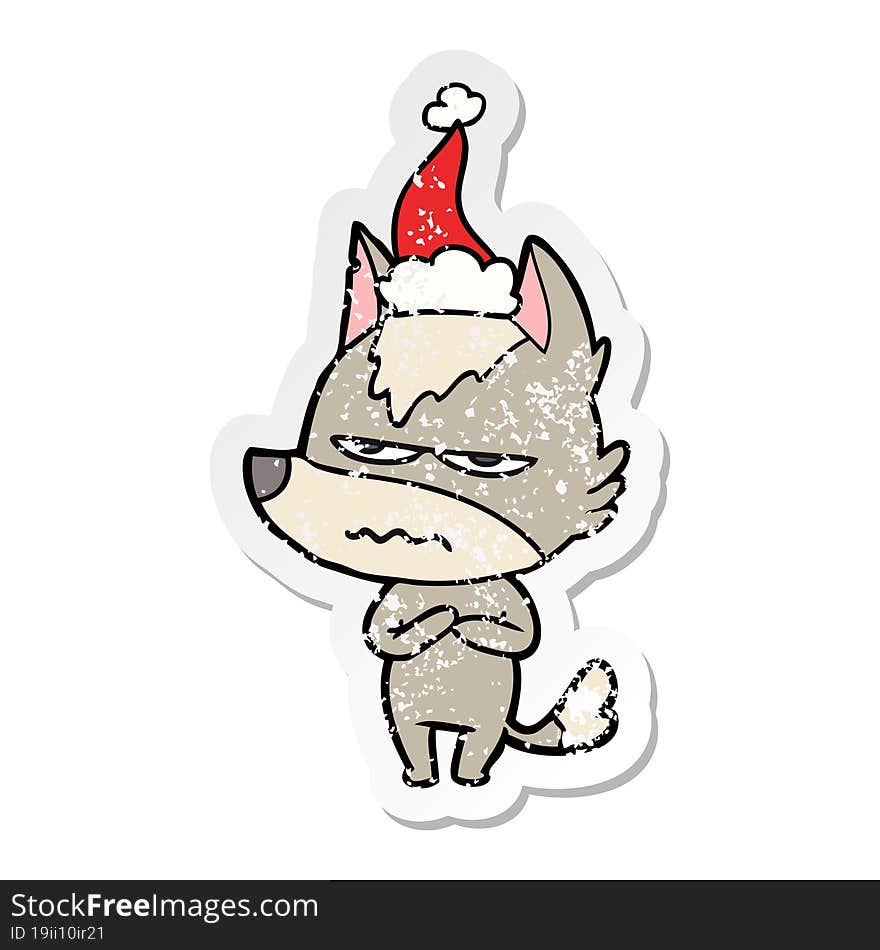 hand drawn distressed sticker cartoon of a annoyed wolf wearing santa hat