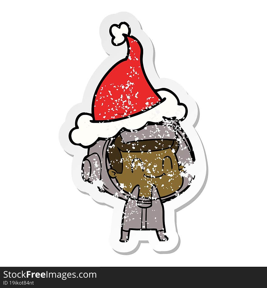 happy distressed sticker cartoon of a astronaut wearing santa hat