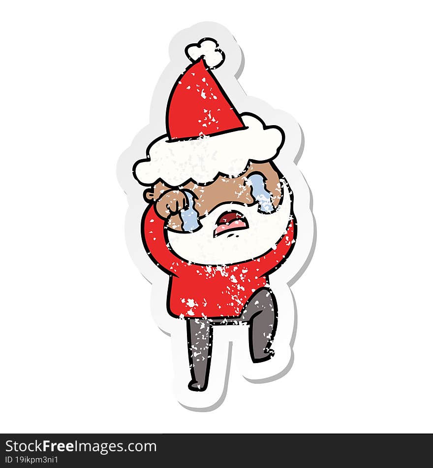 distressed sticker cartoon of a bearded man crying and stamping foot wearing santa hat