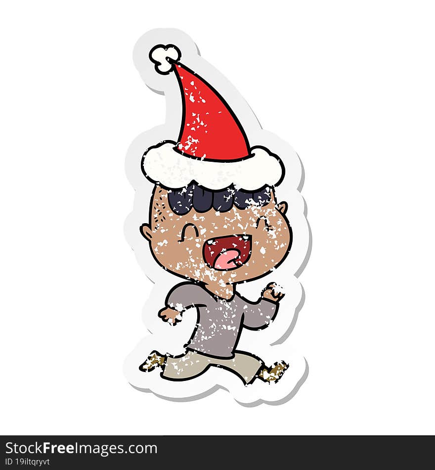 distressed sticker cartoon of a happy boy laughing and running away wearing santa hat